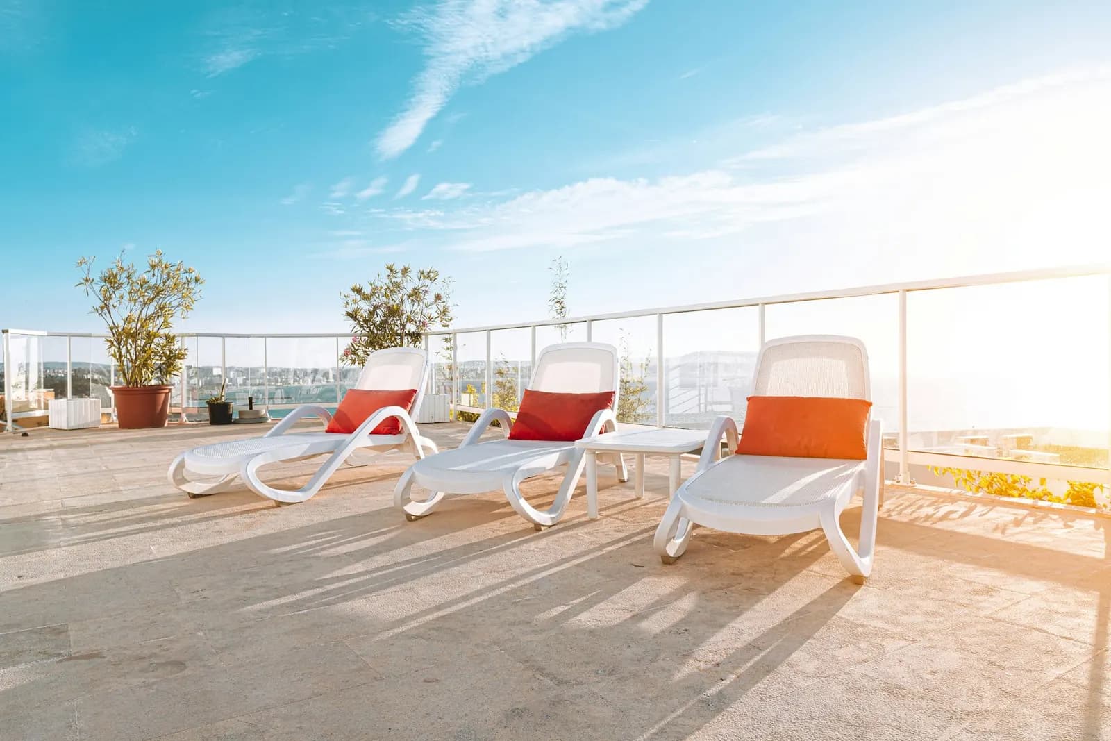 Sun loungers with outdoor cushions on a terrace